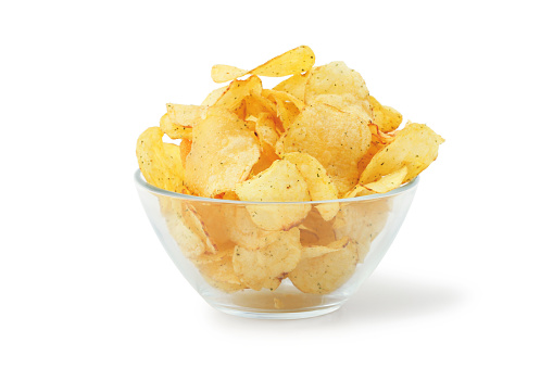 Potato chips in glass bowl isolated on white background
