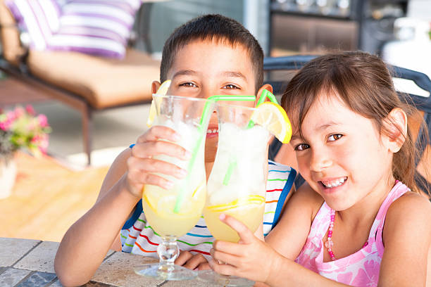 istock Sibling enjoying lemonade outdoor 186859152