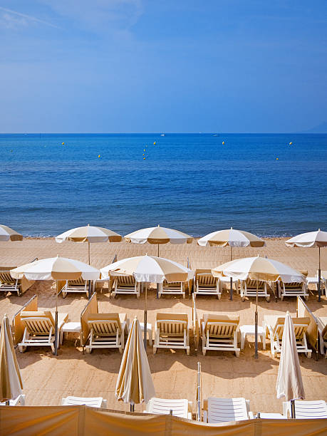 French riviera Neatly arranged beach in Cannes, France. french riviera stock pictures, royalty-free photos & images