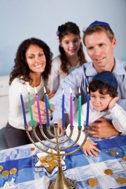 istock Family celebrating Hanukkah 186859681