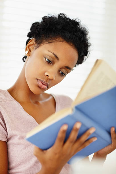 istock African American young lady reading book 186859818