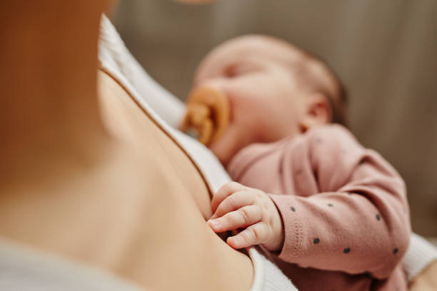 istock Sleeping Baby Laying Hand on Mothers Chest 1868599156