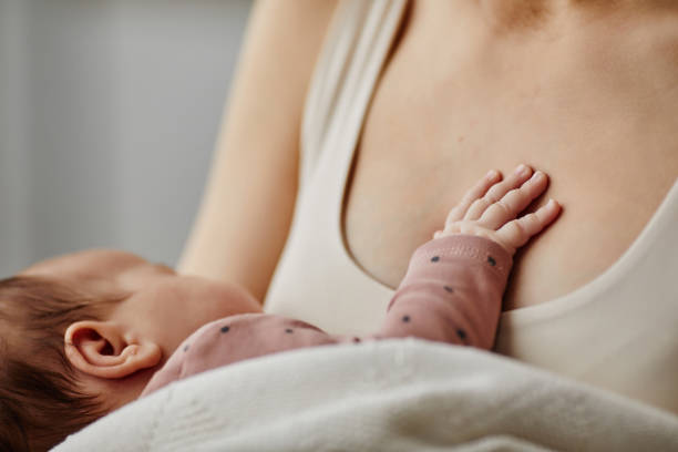 istock Tiny Baby Hand on Moms Chest 1868599159
