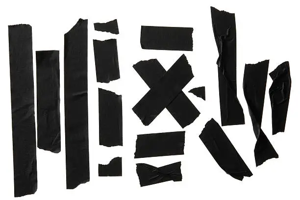 Different stripes of adhesive black tape. All against white background.Studio shot.