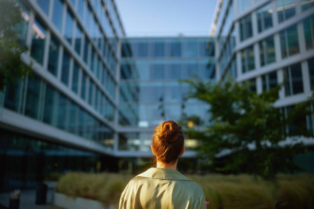 istock Seen from behind female worker near office building 1868603053