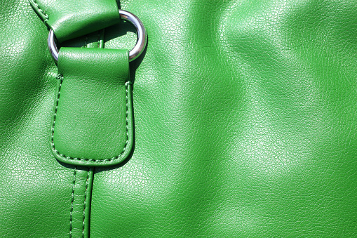 close up shot of green leather bag.