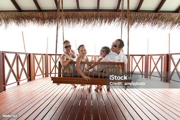 Happy Family In Swing Stock Photo - Download Image Now - Bungalow, Family, Adult