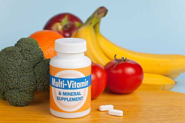 multi-vitamins with fruit and veggies - multi vitamine stockfoto's en -beelden