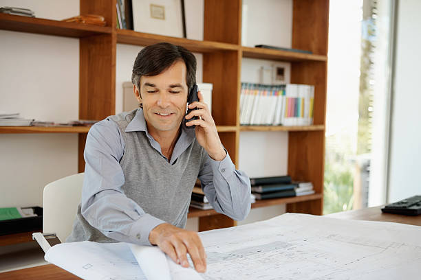 istock Architect discussing his new project on the phone 186862188