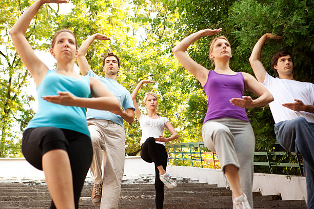 istock Tai Chi: Group of Young People Practicing Outdoor 186862382