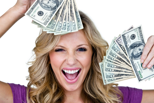 Woman with very excited look on her face holding money and isolated on white background 