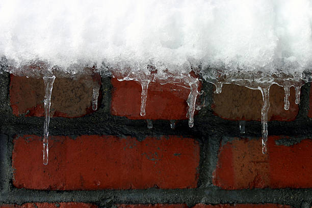 icycle at chimney brick masonry :  winter snow stock photo
