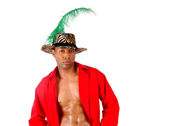The Pimp A young man wearing a red shirt and a pimp hat with feather against a white background. pimp hat stock pictures, royalty-free photos & images