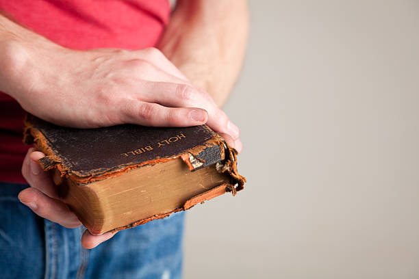 Man holding his old used bible