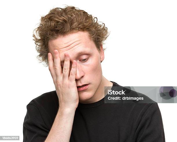 Disappointed Young Man Rubs Face Stock Photo - Download Image Now - Men, Tired, 20-24 Years