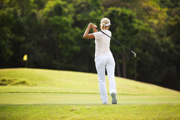 istock Rear view of a woman playing golf 186865085