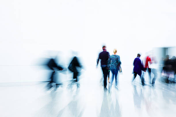 istock Blurred people walking toward a door in a hallway 186865471