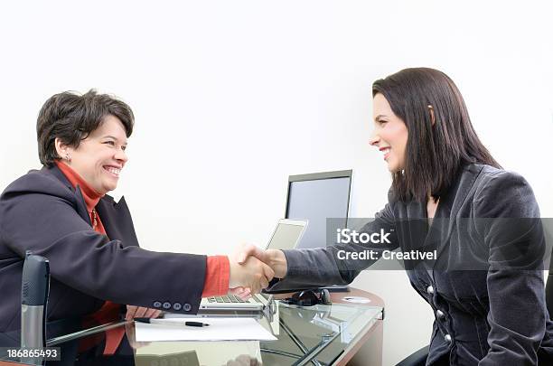 Two Businesswomen Shaking Hands Stock Photo - Download Image Now - 30-39 Years, Adult, Adults Only