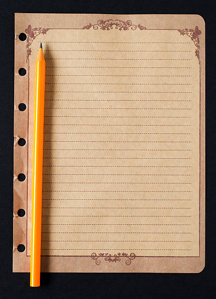 istock Pencil and old paper on black background 186865587