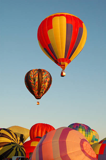 istock Two Hot Air Balloons Lifting Off 186865673