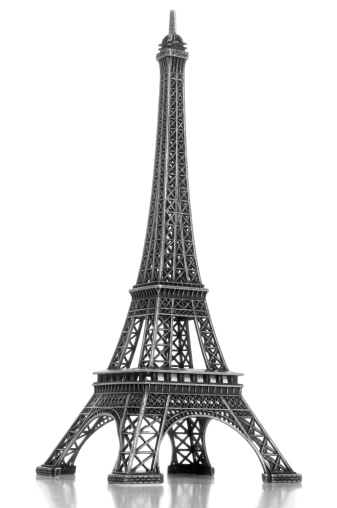 A model Eiffel tower souvenir isolated on white with reflection.