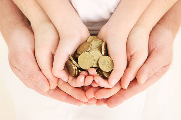 istock Three pairs of concentric hands with gold coins 186866157