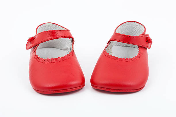 red baby girl booties isolated in white background.