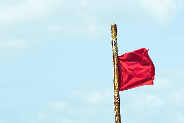 istock red banner flag against blue cloud sky 186866234