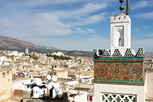 Ancient Medina of Fez with a minaret in foreground in a sunny day.