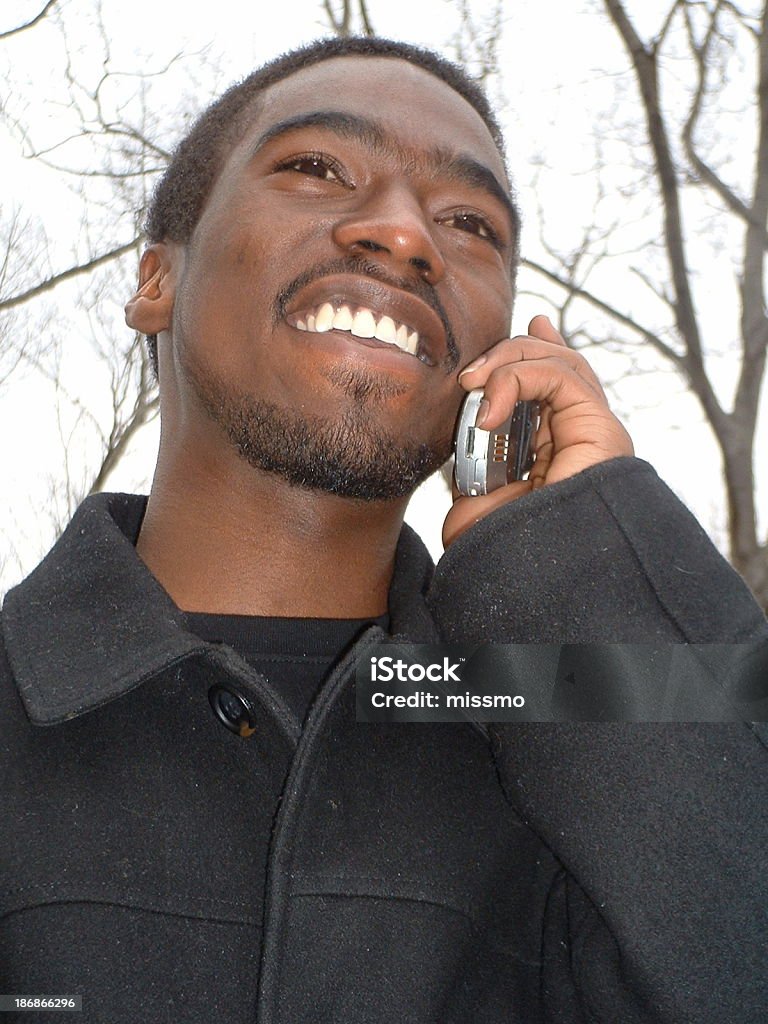 Young man on the telephone 18-year old african american man on a cell phone. Adult Stock Photo