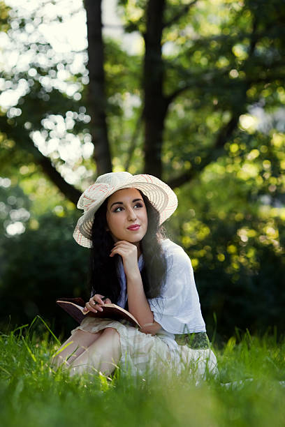 istock attractive girl sitting and reading book 186866393