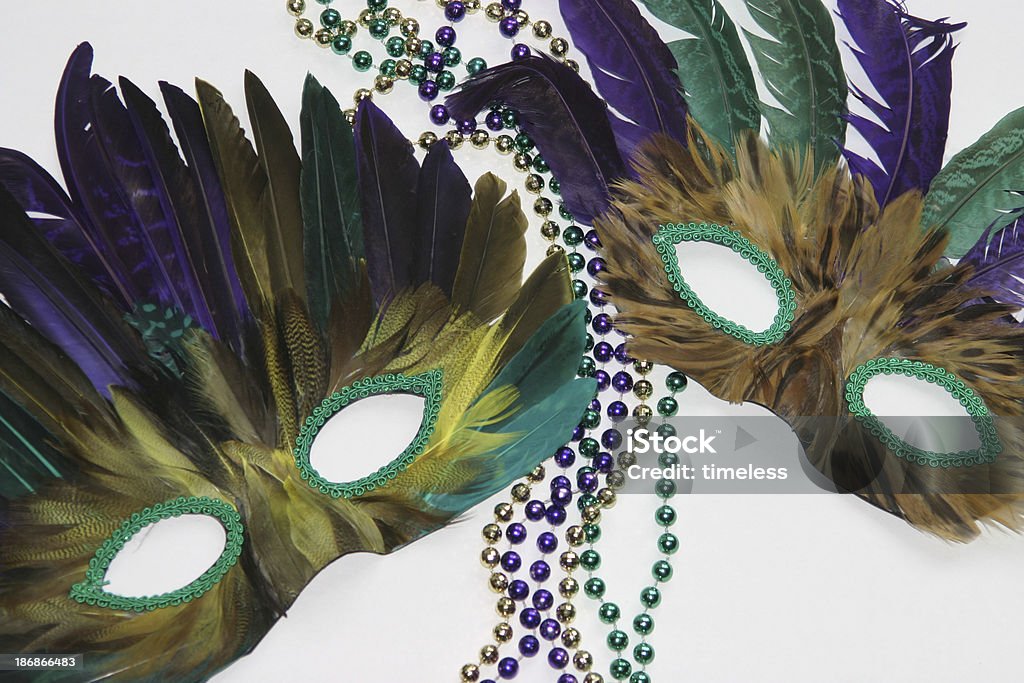 Mardi Gras mask 2 Two Mardi Gras masks and beads on a white background. Mardi Gras Stock Photo