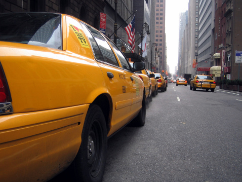 New York, NY, USA - July 5, 2022: Yellow cabs on the streets in Midtown Manhattan, New York City.