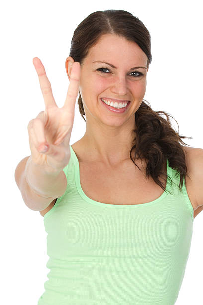 istock woman gesturing peace sign 186867010