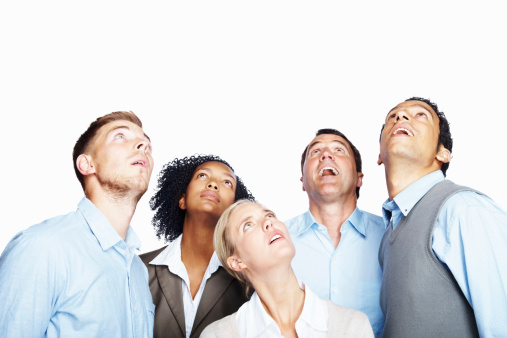 Surprised business people looking up at copy space against white background