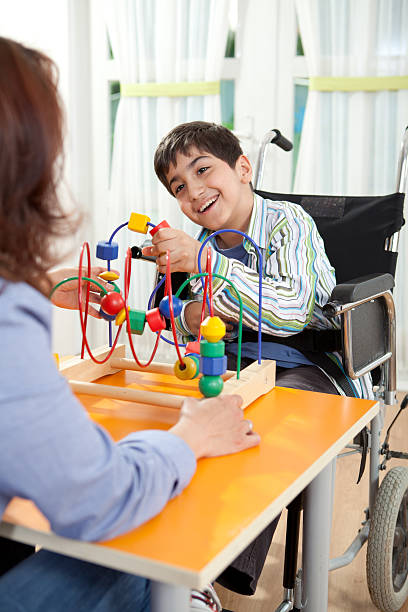 istock Little Boy With Cerebral Palsy and Teacher 186867765