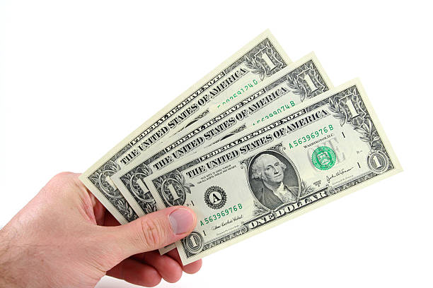 Three Dollars in Hand Holding three one dollar bills three animals photos stock pictures, royalty-free photos & images