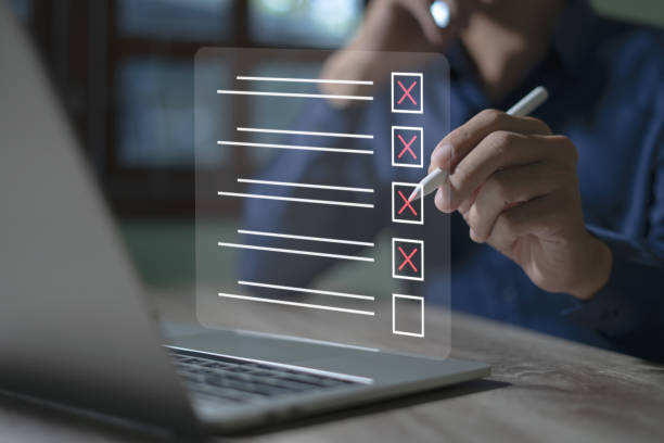 istock Smart checklist concept on virtual screen A man uses a marker to explore topics in a digital form review document. 1868680157