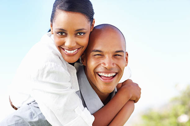 istock Young couple enjoying a piggyback ride in park 186868090
