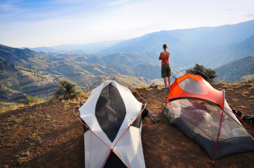 A hiker admires the view across Hells Canyon from her campsite on a backpacking trip.