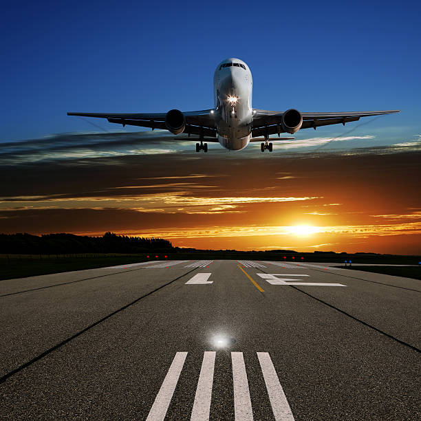 istock XL jet airplane landing at sunset 186869187