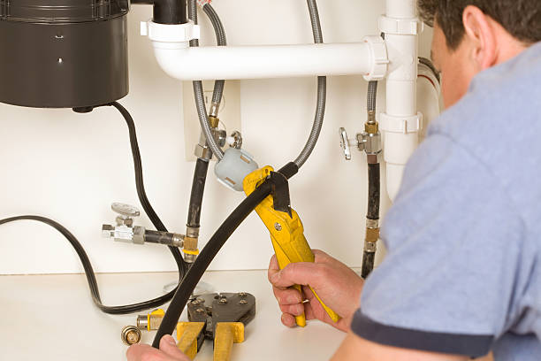 istock Plumber Cutting Plastic Water Tubing 186869244