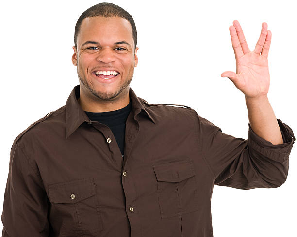 Smiling Man Gives Vulcan Salute Portrait of a young man on a white background. http://s3.amazonaws.com/drbimages/m/ns.jpg vulcan salute stock pictures, royalty-free photos & images