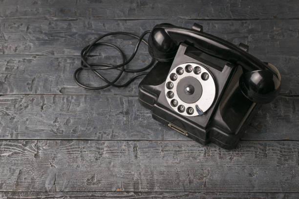 istock Vintage classic phone on a wooden background. 1868694137