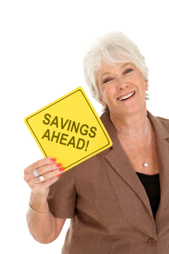 Mature woman holding sign saying savings ahead