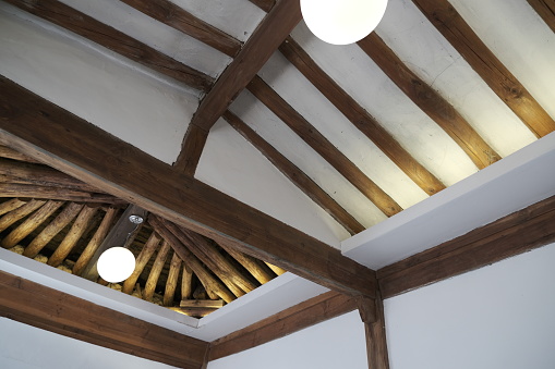 The roof beams show traditional ceiling of korean housing