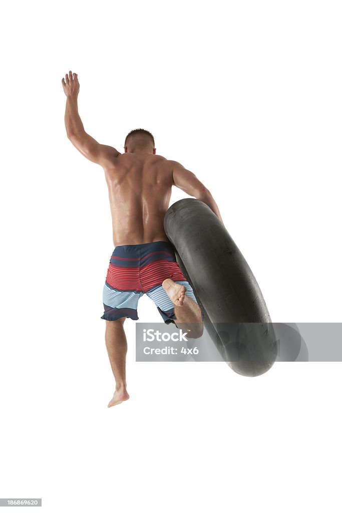 Homem Saltar com Boia de Pneu - Royalty-free 20-29 Anos Foto de stock