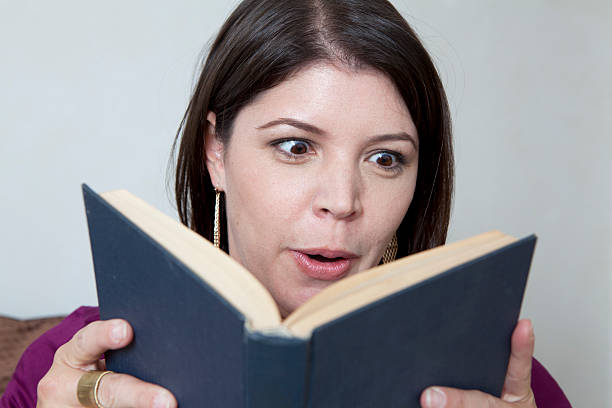 istock Exciting Read. Woman Reads Book Horizontal 186869642