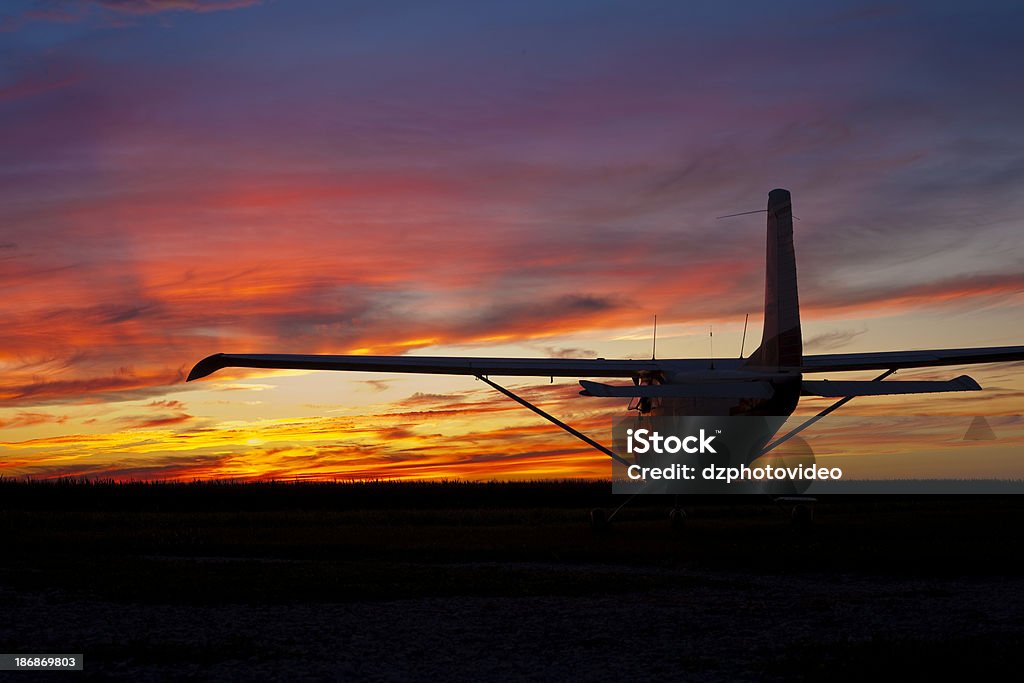 Cessna Sunset A parked Cessna airplane during sunset Airplane Stock Photo