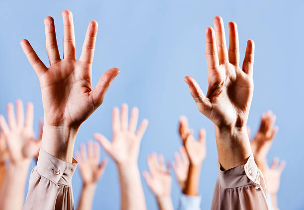 istock Hallelujah! Hands raised enthusiastically against blue background 186870350